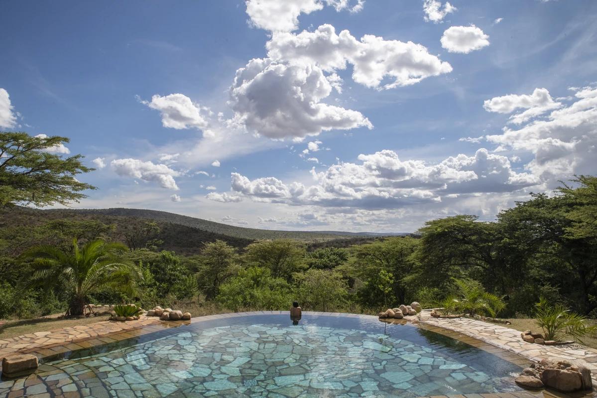 Cottar’s 1920s Camp swimming pool overlooking the Maasai Mara landscape in Kenya.
