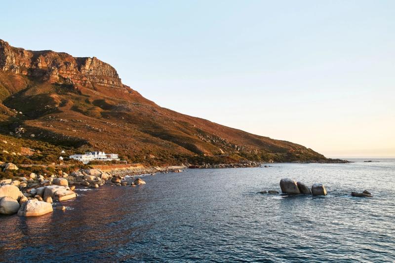 A coastal hotel set against a rugged mountainside, perfectly isolated among the luxury hotels in Cape Town
