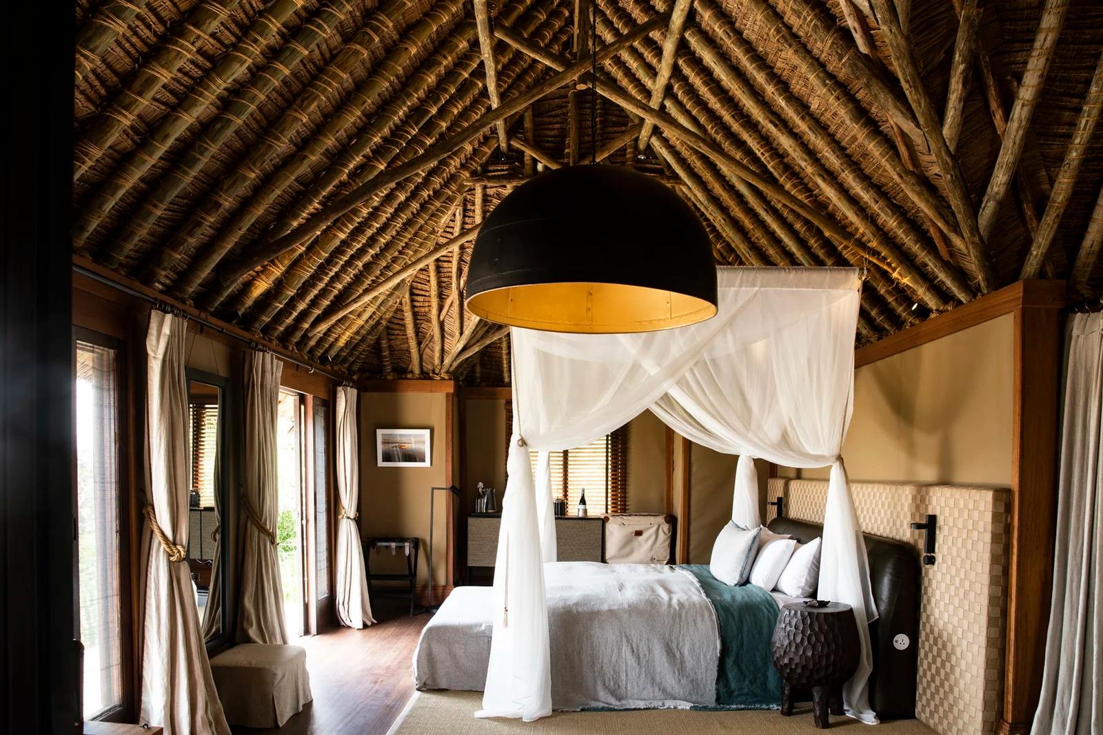 Segeera Retreat guest room with comfortable furnishings and views of the surrounding Kenyan wilderness.