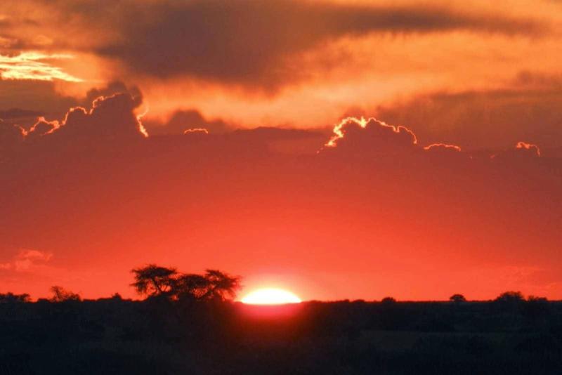 "At the top of one of the dunes we watched the sun set. The barman at the lodge had snacks and drinks waiting for everyone. It was a beautiful sight to see the sun set over the Kalahari Desert."