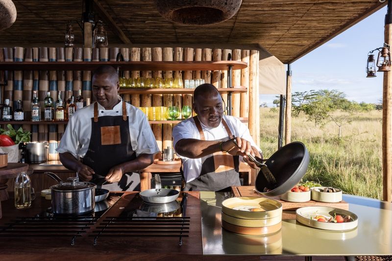 Two staff members preparing food and drinks