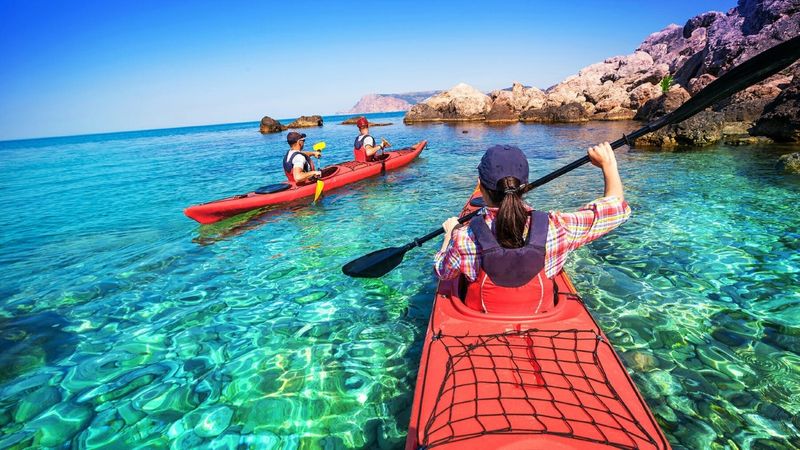 Two red kayaks on crystal clean water in Hout Bay