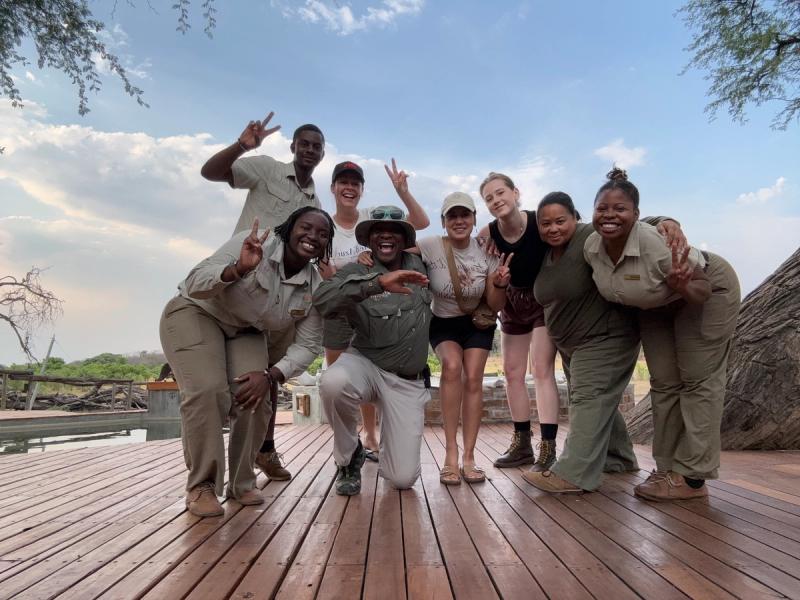 Women pose for a photograph while on a Zimbabwe Safari