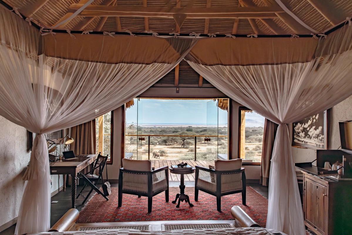 Ol Donyo guest room with a comfortable bed and views across the surrounding landscape.