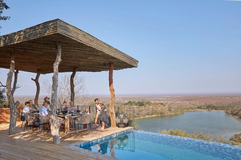 Singita Malilangwe House multigenerational family having lunch on the private pool deck