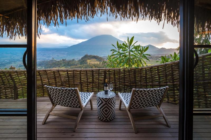 A private deck overlooking Volcanoes National Park during the drier season, the best time to visit Rwanda