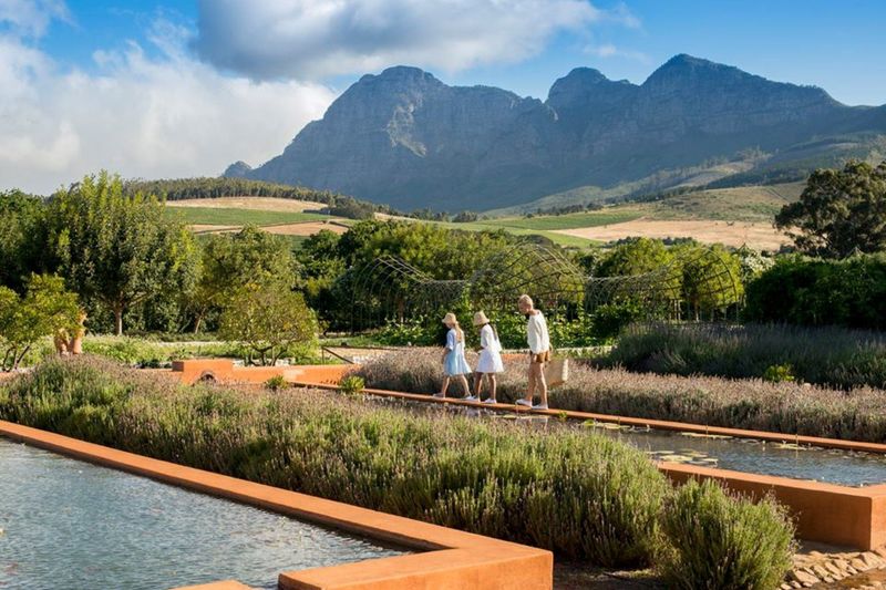 Enfants jouant dans les piscines de Babylonstoren, vue sur les montagnes.