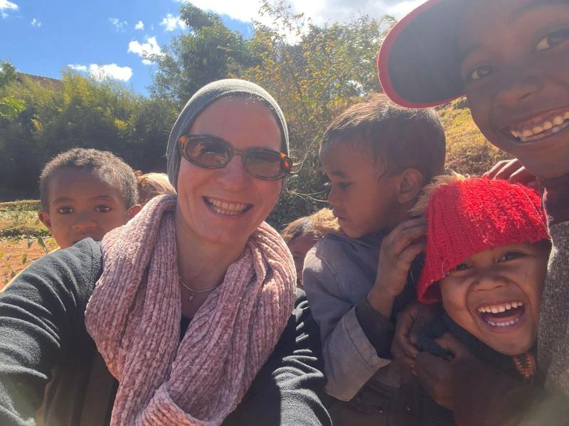 Manuela smiling with four children in the Madagascan countryside