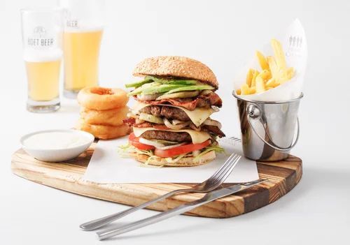 Double stacked burger served with fries, onion rings, dipping sauce and two glasses of beer