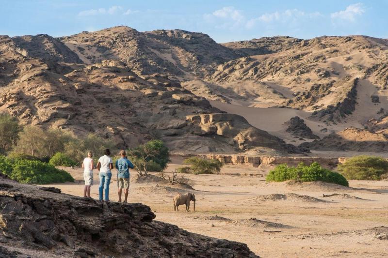 Safari goers on foot near Hoanib Skeleton Coast Lodge in Namibia