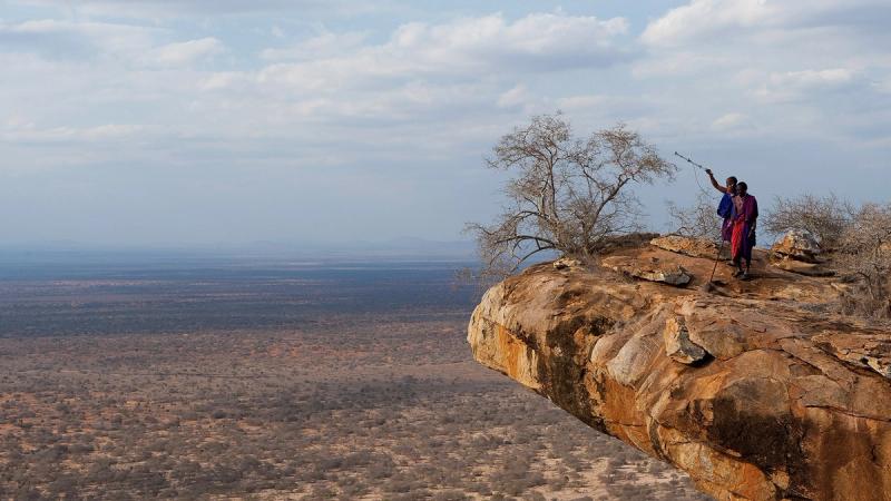 Two Maasai guides use modern technology to collect data about the land