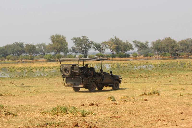 Game-drive vehicle looking out over river in South Luangwa Park