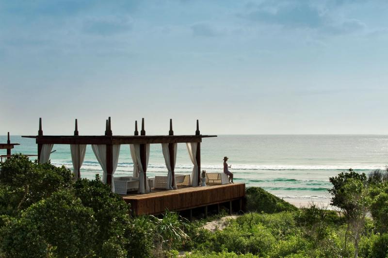 A private wooden viewing deck with shaded lounge seating overlooking the Indian Ocean at White Pearl Ponta Mamoli Resort in Mozambique.