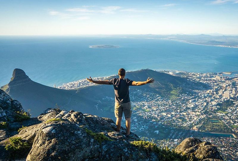 Mann blickt vom Tafelberg auf die Innenstadt