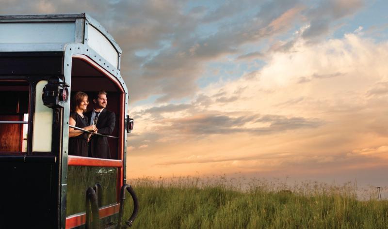 Couple looking out onto African plains from Rovos Rail Luxury Train