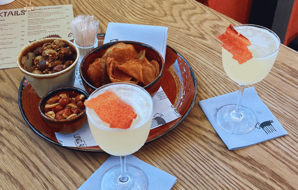 Cocktals and snacks with free-flowing conversation at Unclaimed Bar in Cape Town