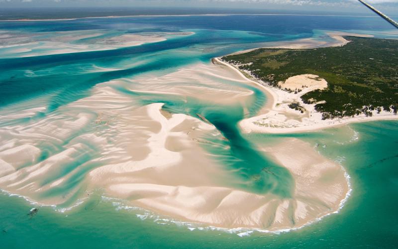 Aerial view of white sandbanks and turquoise tidal channels surrounding andBeyond's Benguerra Island in Mozambique’s Bazaruto Archipelago.