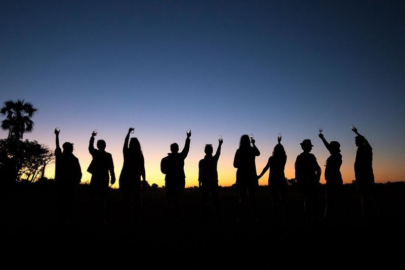 Our travel experts enjoying a sunset on safari in Botswana