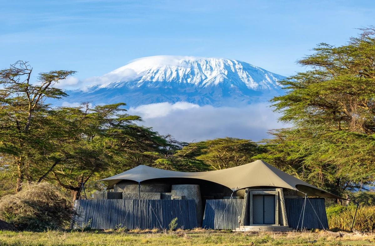 Angama Amboseli guest tent with a comfortable bed and views of the surrounding landscape.
