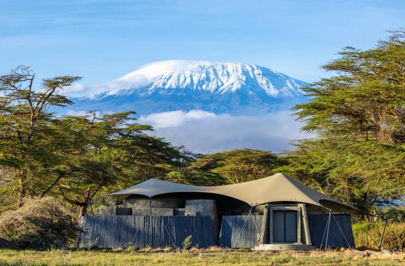 An exterior image of a guest suite at Angama Amboseli with a snow capped Mount Kilimanjaro in the background