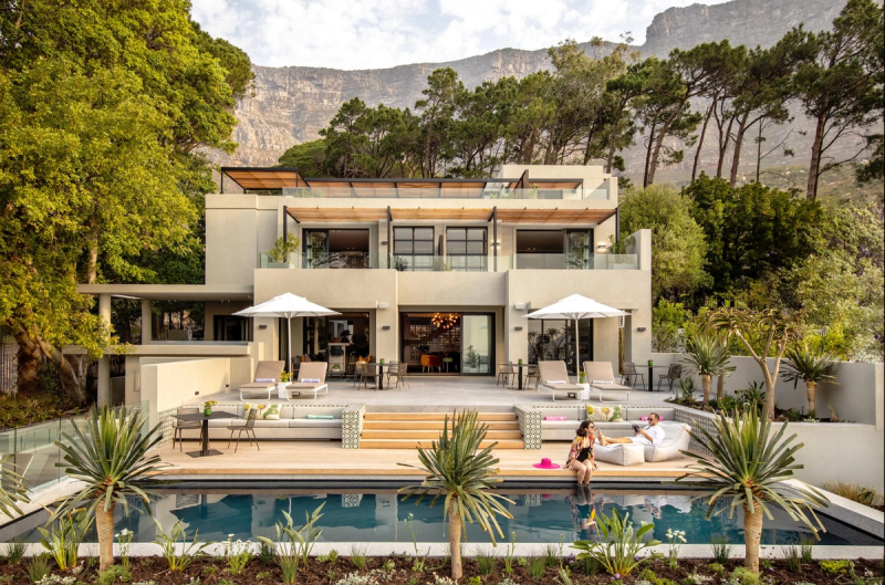 A contemporary villa-style property with a pool and mountain backdrop, representing one of the luxury hotels in Cape Town