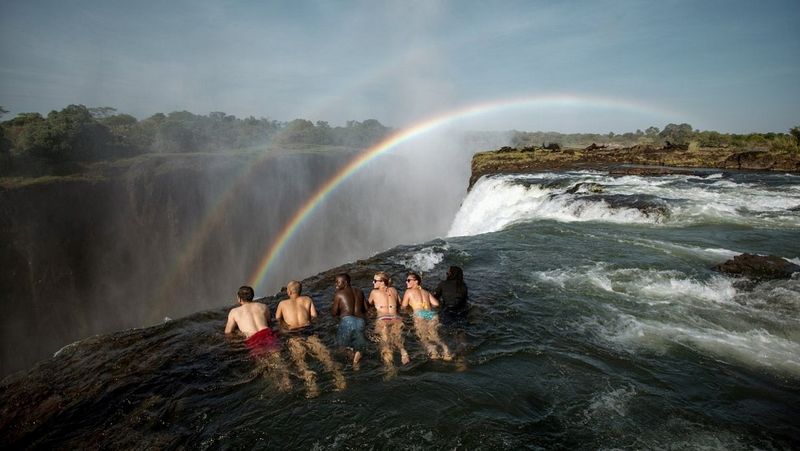 Friends swimming at the edge of Devil's Pool