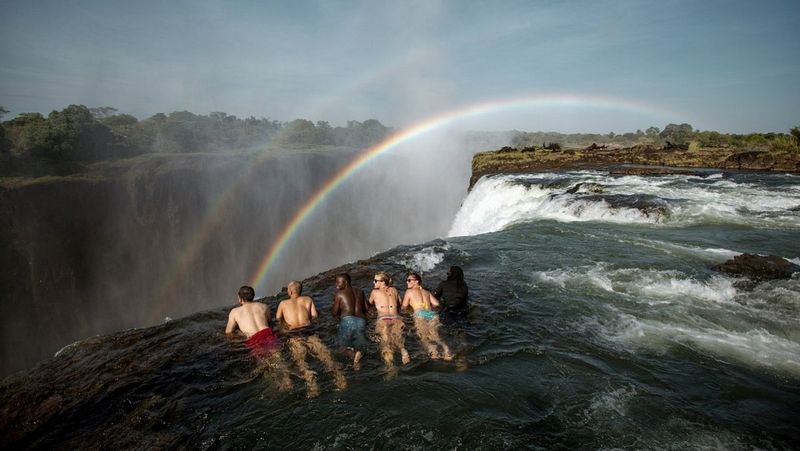 Friends swimming at the edge of Devil's Pool