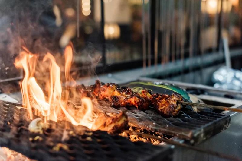 Flmae-grilled kebabs on a grid 