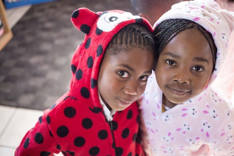Two girls dressed up in onesies at Khumbulani
