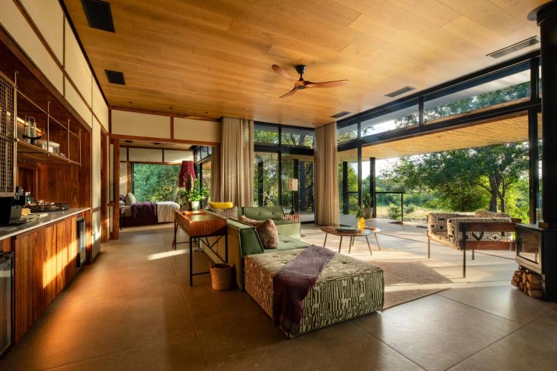 Spacious open-plan bedroom suite with floor-to-ceiling windows overlooking bushveld landscape in Timbavati Nature Reserve