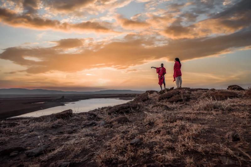 A Maasai guide shows a guest the views of the northern Kenya landscape