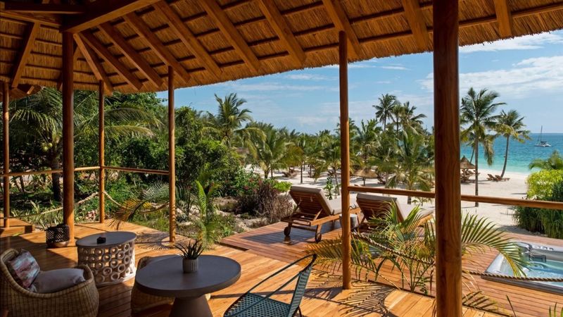 Viewing deck overlooking beach, palm trees and ocean