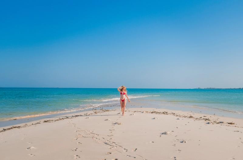Girl standing on Coral Lodge's private beach in Ilha de Moçambique.