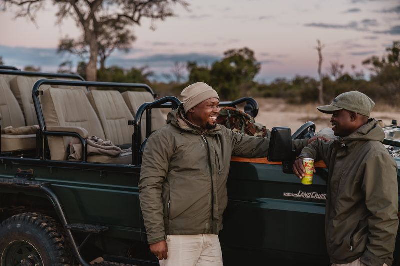 Tanda Tula guide and tracker enjoying sundowners on a game drive 