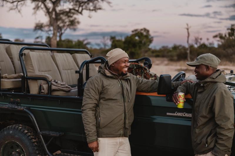 Tanda Tula guide and tracker enjoying sundowners on a game drive