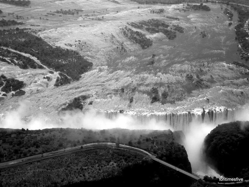 "Welcome to Mosi~oa~Tunya or Smoke that Thunders. The first known name of the falls was Shongwe, given by the Tokaleya people. Later, the Ndebele changed the name to Amanza Thunquayo, or Water Rising as Smoke. When the Makalolo arrived it was changed yet again to Mosi~oa~Tunya. And finally when Dr. Livingstone was brought to the falls in a dugout canoe on 16 November 1855, he renamed them in honor of the queen. To me, it's so spectacular, it deserves four names, at least."