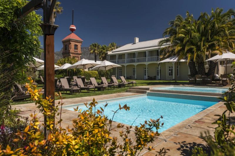 A heritage-style garden with a swimming pool and loungers at one of the luxury hotels in Cape Town