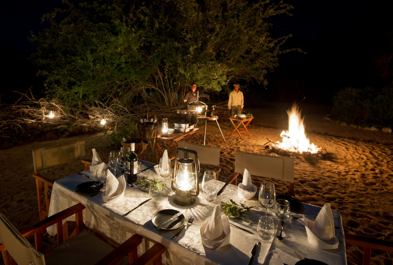 Boma dinner by glowing lamp-light and campfire-cooking
