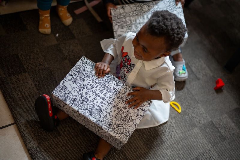 Girl with Santa's Shoebox at the Khumbulani Christmas party
