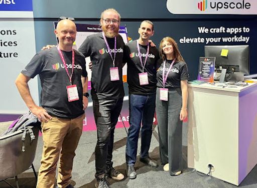 Four members of the Upscale team with branded t-shirts