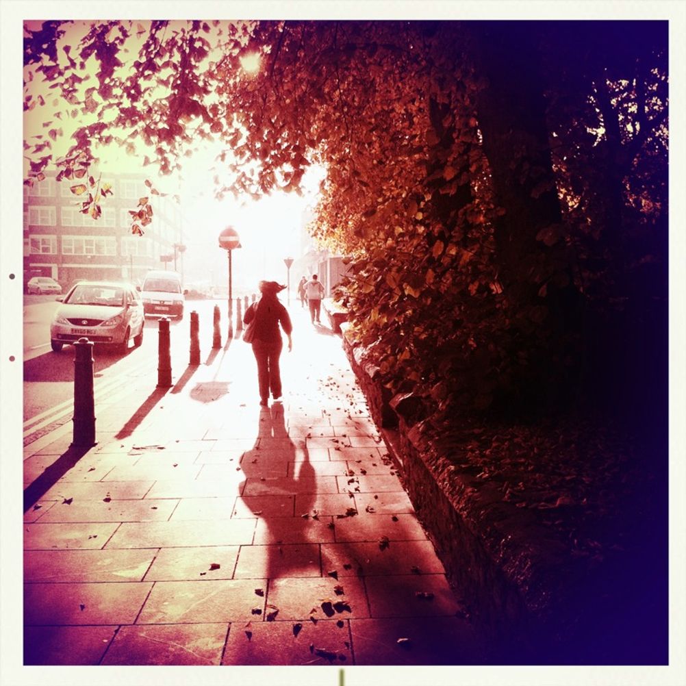 Photo of a woman walking on the street.