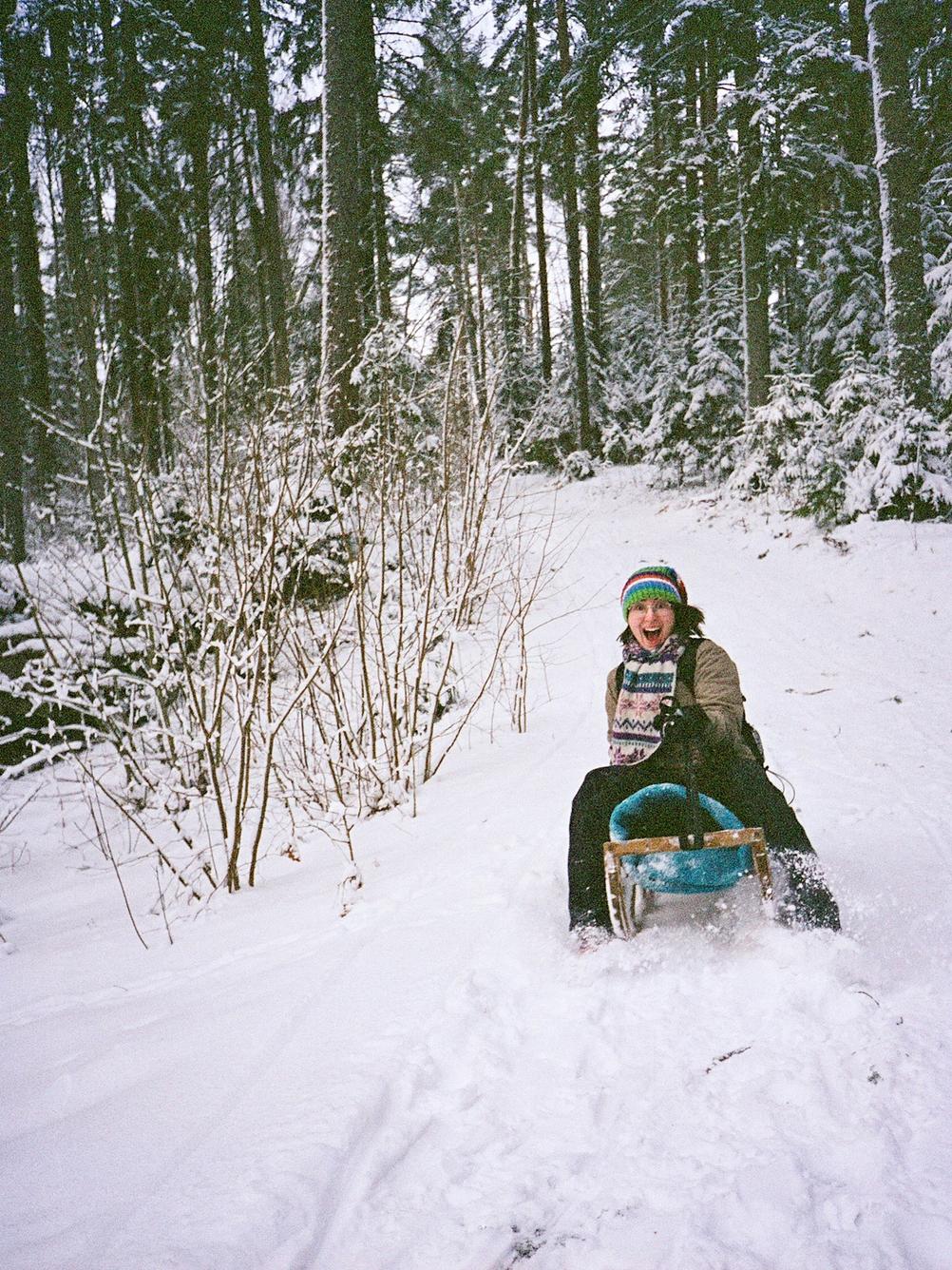 Photo of my wife sliding down a hill with a sled.