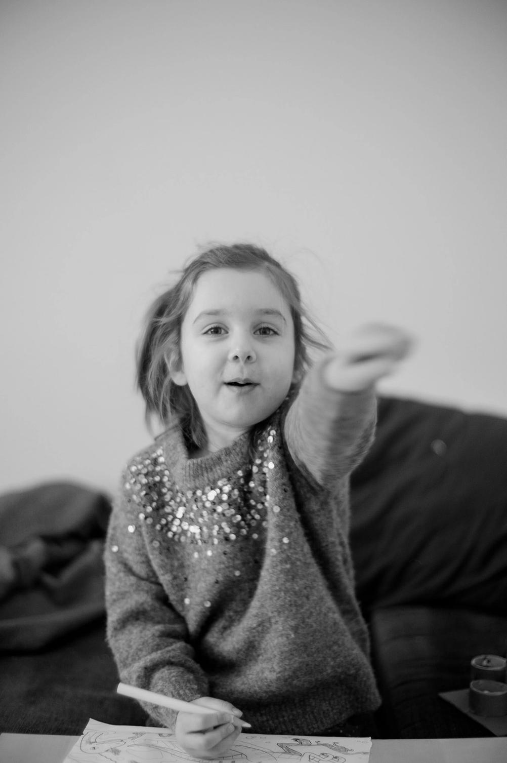 Photo of a girl waving a finger.