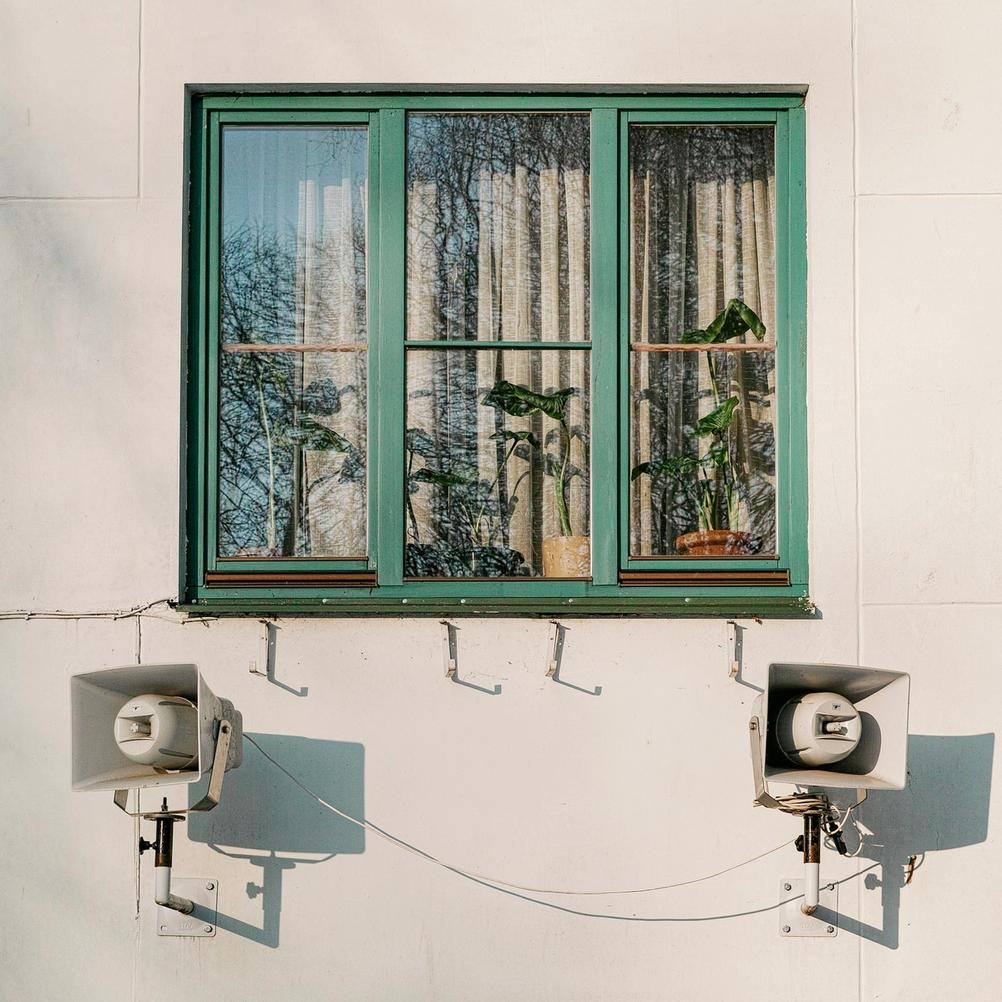 Photo of a window and loudspeakers.