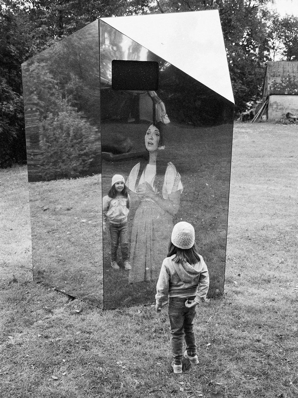 Photo of my daughter next to an art installation.