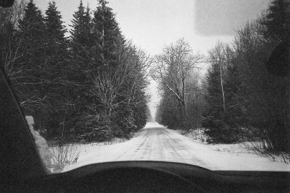 Black and white photo taken through the cars windscreen.