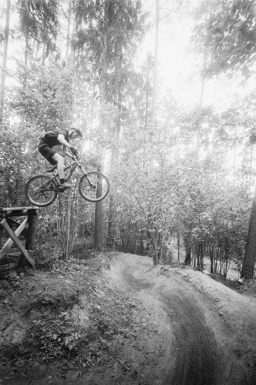 Photo of a downhill rider jumping.