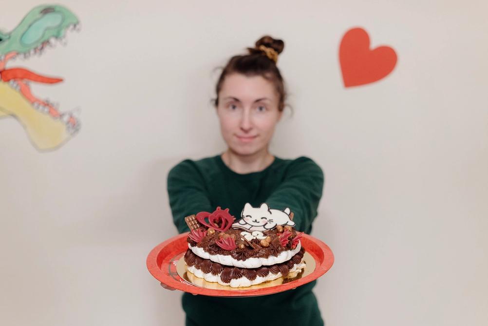 Photo of my wife holding a cake.