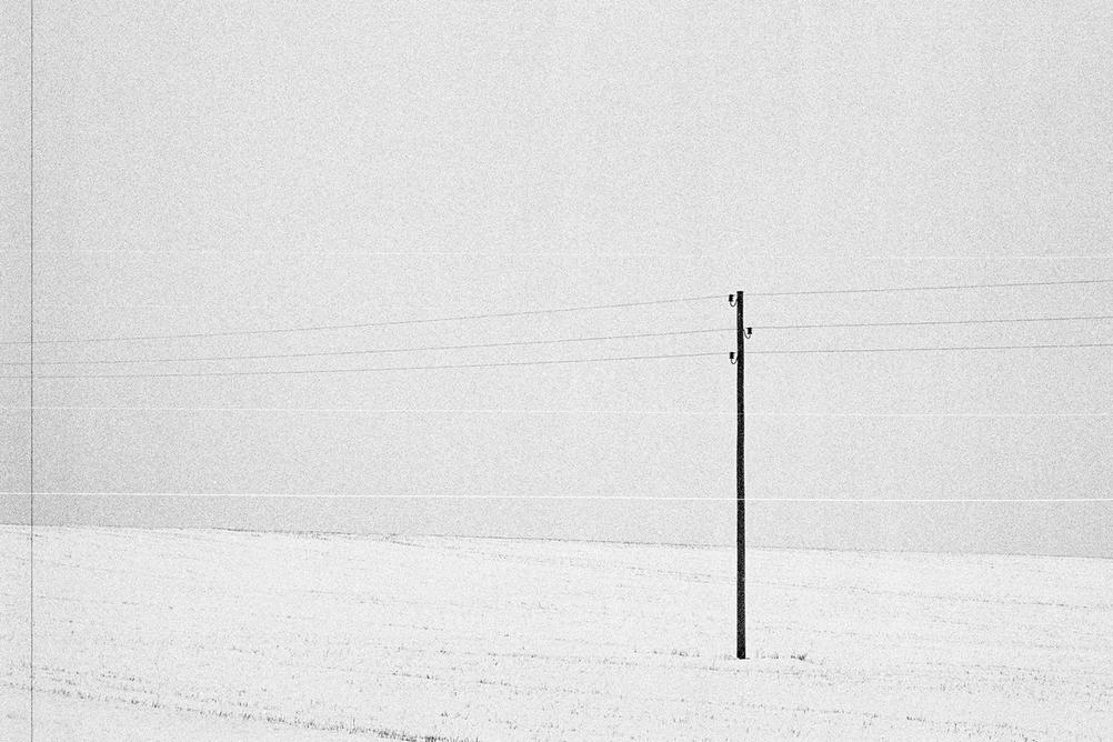 Photo of a lonely electricity pole.
