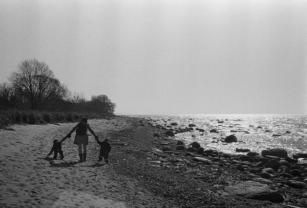 Photo of my wife and two children walking on the beach.
